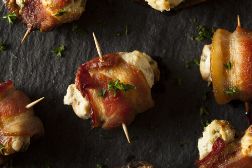 Need a keto appetizer recipe? You can’t go wrong with these bacon wrapped keto stuffed mushrooms! Easy low carb, high protein mushrooms filled with cream cheese, cheddar, and Parmesan & wrapped in bacon make fabulous finger foods for a crowd! Try this delicious keto stuffed mushroom appetizer at your next party! Nobody will guess it’s healthy keto diet food!