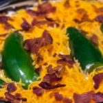 This Keto Chicken Jalapeno Popper Casserole with bacon is what an easy, low carb dinner is all about! Shredded chicken breasts covered in a fabulous combination of cream cheese, heavy cream & garlic with jalapeno peppers topped with cheddar cheese & bacon. Keto comfort food with 4.3 net carbs! #keto #ketorecipes #ketodinner #lowcarb #casserole #Jalapeno #JalapenoPopper #chicken #dinner