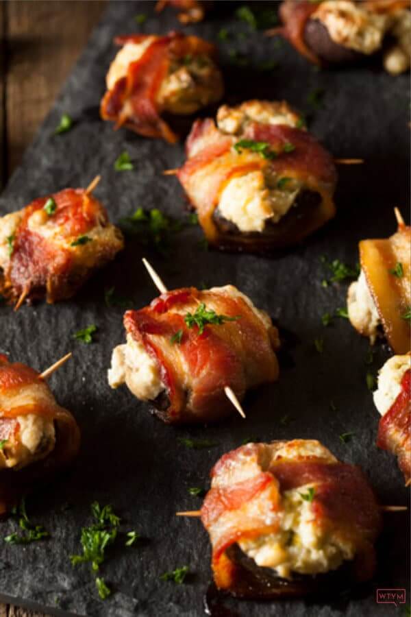 Keto Appetizer Recipes! You can’t go wrong with these bacon wrapped keto stuffed mushrooms! Easy low carb, high protein mushrooms filled with cream cheese, cheddar, and Parmesan & wrapped in bacon make fabulous party appetizers for a crowd! Try this delicious keto stuffed mushroom appetizer at your next party! Nobody will guess it’s healthy keto diet food! #keto #ketorecipes #lowcarbrecipes