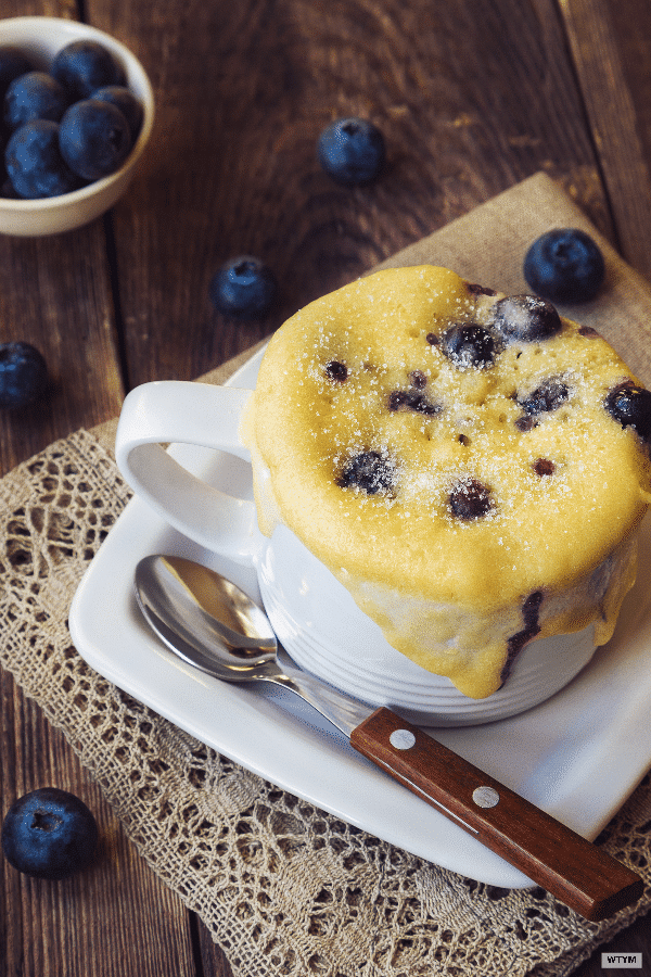 Easy Keto Microwave Blueberry Mug Cake Recipe. This keto mug cake is perfect for a quick breakfast, snack or dessert! Learn how to curb cravings in minutes using your microwave, almond flour, coconut flour, vanilla and blueberries! This will be your new favorite quick low carb, gluten-free, paleo and keto-friendly muffin in a mug recipe with 5.7 net carbs! #keto #ketorecipes #ketomugcake #lowcarbmugcake #mugcakes #lowcarb #ketodesserts #paleodesserts #glutenfreedesserts